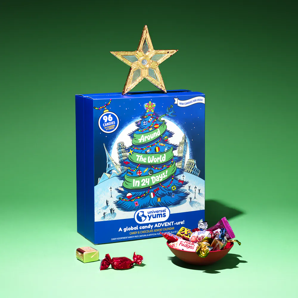 The Around The World Candy Advent Calendar box with a gold star on top and a bowl of international candy.